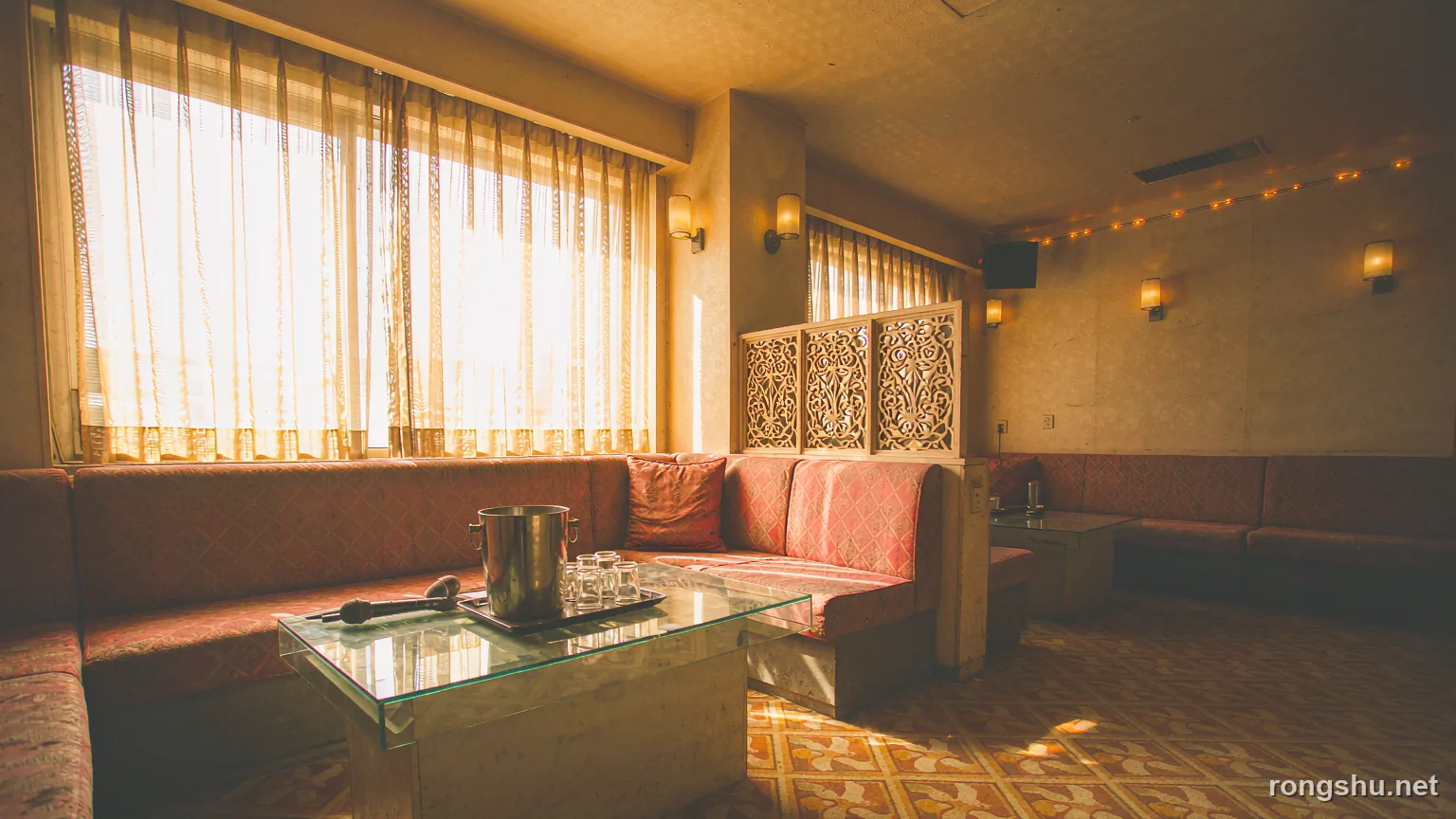 the sunlit interior of an empty private karaoke room in Kunming with a vermilion banquette and warm string lights - Chinese true crime illustration